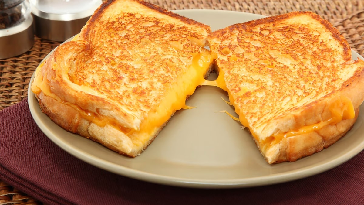 A plate with a variety of cheese slices, highlighting the tooth-strengthening benefits.