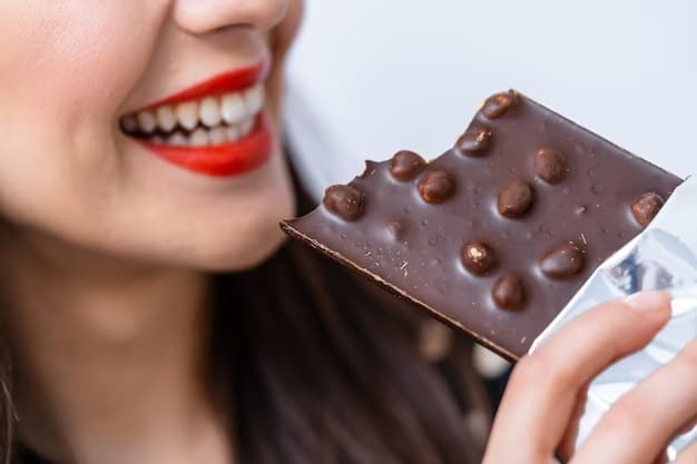 A person enjoying a piece of dark chocolate with a happy smile.