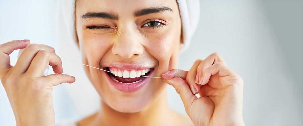 A person with a bright and healthy smile demonstrating good oral hygiene practices.