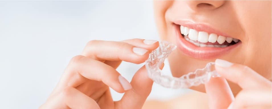 A person with a confident smile, showcasing the effectiveness of Invisalign in Decatur, GA.